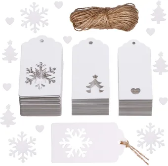 Kraft gift tags with cut-out snowflakes and trees, beside a roll of twine